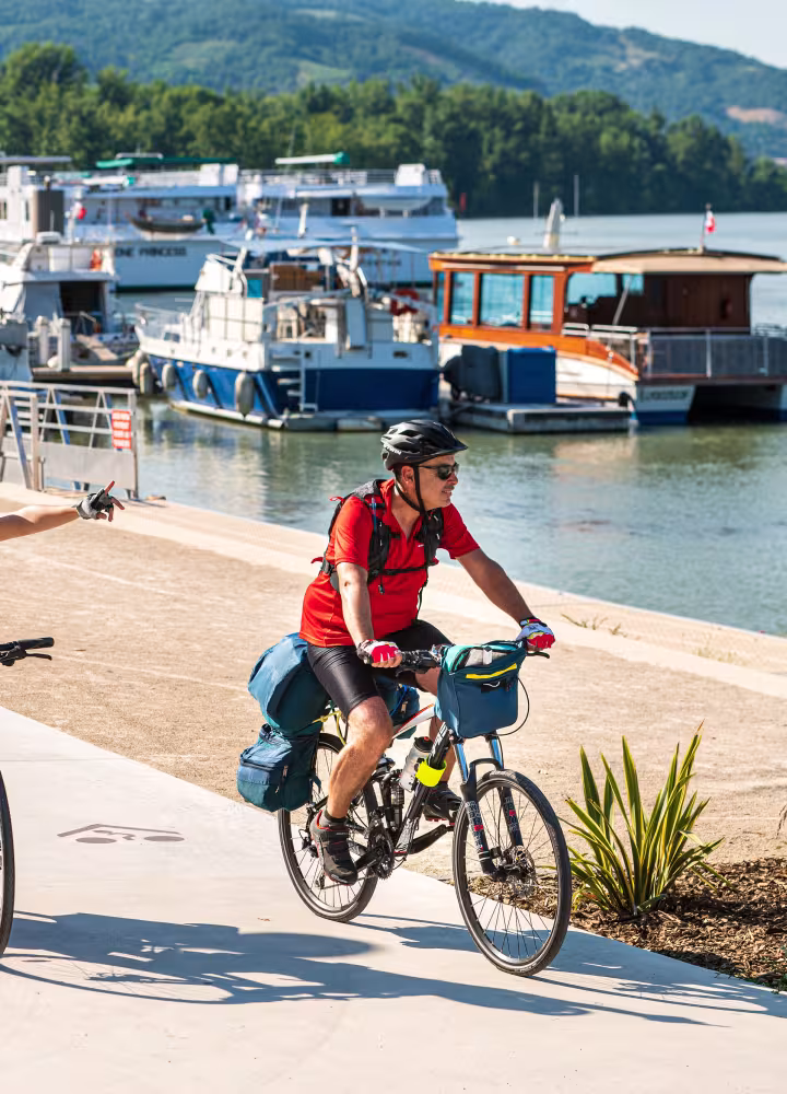 Couple cycling along the quays of Tournon sur Rhône (Ardèche)