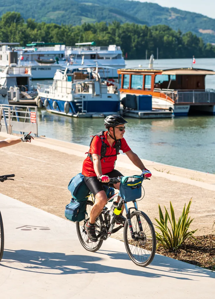 Couple cycling along the quays of Tournon sur Rhône (Ardèche)